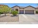 Beautiful single-story home with a well-maintained yard, mature landscaping, and a two-car garage at 18455 W San Carlos Dr, Goodyear, AZ 85338
