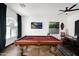 Bright game room with a pool table, television, and comfortable dining area for endless entertainment possibilities at 18455 W San Carlos Dr, Goodyear, AZ 85338