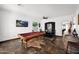 Inviting game room with a pool table, dining area, and artistic accents for a unique entertainment space at 18455 W San Carlos Dr, Goodyear, AZ 85338