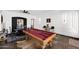 Elegant game room featuring a pool table, unique artwork, and rustic accents for a cozy atmosphere at 18455 W San Carlos Dr, Goodyear, AZ 85338