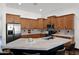 Open kitchen with stainless steel appliances, a center island with seating and stone countertops at 18455 W San Carlos Dr, Goodyear, AZ 85338