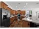 Well-equipped kitchen featuring stainless steel appliances, custom cabinetry, and a center island with ample counter space at 18455 W San Carlos Dr, Goodyear, AZ 85338