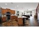Modern kitchen with stainless steel appliances, granite countertops, island with bar seating, and open floor plan at 18455 W San Carlos Dr, Goodyear, AZ 85338