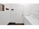 Functional laundry room with a washer and dryer, a door with an electronic keypad, and dark tile flooring at 18455 W San Carlos Dr, Goodyear, AZ 85338