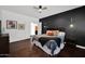 Relaxing main bedroom features elegant dark accent wall and a spacious layout at 18455 W San Carlos Dr, Goodyear, AZ 85338