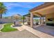 Spacious outdoor patio with built-in BBQ, pergola, and ample seating area, ideal for entertaining and relaxation at 18455 W San Carlos Dr, Goodyear, AZ 85338