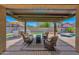 Covered outdoor patio with stylish seating area and view of the pool and BBQ area, perfect for outdoor living at 18455 W San Carlos Dr, Goodyear, AZ 85338