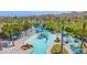 Aerial view of an incredible community waterpark featuring slides, lounge chairs, and lush landscaping at 18455 W San Carlos Dr, Goodyear, AZ 85338