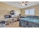 Bedroom with a large window, ceiling fan, and desk space, ideal for a home office or study area at 1923 N Cocoa Ct, Casa Grande, AZ 85122