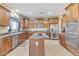 Well-lit kitchen with stainless steel appliances, a central island, and ample cabinet space at 1923 N Cocoa Ct, Casa Grande, AZ 85122