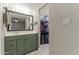 Well-lit bathroom featuring a sink, a large mirror, and a walk-in closet at 1927 E Hampton Ave # 204, Mesa, AZ 85204
