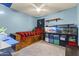 Well-lit bedroom with blue walls, carpeted floors, and a built-in bed frame at 1927 E Hampton Ave # 204, Mesa, AZ 85204