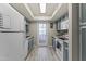 Galley kitchen featuring essential appliances and streamlined cabinets at 1927 E Hampton Ave # 204, Mesa, AZ 85204