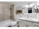 Bathroom featuring a shower over tub with grey tile, white vanity with marble countertops at 2021 E Osborn Rd # 9, Phoenix, AZ 85016