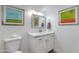 Bathroom featuring a white vanity with marble countertops and decorative wall art at 2021 E Osborn Rd # 9, Phoenix, AZ 85016