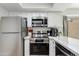 Close up of a modern kitchen with stainless appliances, white cabinets, and marble countertops at 2021 E Osborn Rd # 9, Phoenix, AZ 85016
