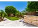This backyard has a built in grill, green lawn, palm trees, and a concrete patio, perfect for outdoor relaxation at 20563 W Edgemont Ave, Buckeye, AZ 85396
