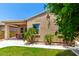 Backyard features a covered patio, desert landscaping, and exterior of home at 20563 W Edgemont Ave, Buckeye, AZ 85396