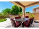 Inviting covered patio with an outdoor kitchen area and comfortable seating, perfect for entertaining at 20563 W Edgemont Ave, Buckeye, AZ 85396