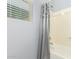 Bathroom featuring a shower-tub combo with a decorative shower curtain at 20563 W Edgemont Ave, Buckeye, AZ 85396