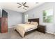 Serene bedroom with a ceiling fan, neutral walls, and plenty of natural light at 20563 W Edgemont Ave, Buckeye, AZ 85396