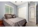 Bedroom featuring neutral walls, bed, and a closet with sliding doors at 20563 W Edgemont Ave, Buckeye, AZ 85396