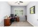 Versatile bedroom with two windows can function as an office with neutral walls and desk at 20563 W Edgemont Ave, Buckeye, AZ 85396