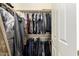 Closet with full rack of hanging clothing and overhead storage at 20563 W Edgemont Ave, Buckeye, AZ 85396