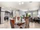Dining room with a glass table, seating for six, and views into the kitchen and living area at 20563 W Edgemont Ave, Buckeye, AZ 85396