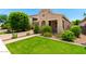 Charming single-story home featuring lush landscaping and a brick-paved driveway at 20563 W Edgemont Ave, Buckeye, AZ 85396