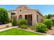 Charming single-story home featuring lush landscaping and a covered porch at 20563 W Edgemont Ave, Buckeye, AZ 85396