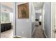 Hallway leading to bedroom and bathroom showcasing neutral walls, carpet, and stylish decor at 20563 W Edgemont Ave, Buckeye, AZ 85396