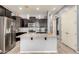 Gourmet kitchen with stainless steel appliances, a center island, and plenty of storage at 20563 W Edgemont Ave, Buckeye, AZ 85396