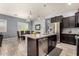 Open kitchen layout with stainless steel appliances, island seating, and a view of the dining area at 20563 W Edgemont Ave, Buckeye, AZ 85396