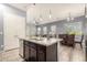 Kitchen island featuring granite countertops, stainless steel sink, and modern pendant lighting at 20563 W Edgemont Ave, Buckeye, AZ 85396