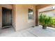 Inviting front porch featuring tile flooring, neutral walls, and a view of the front yard at 20563 W Edgemont Ave, Buckeye, AZ 85396