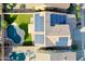 Aerial view of a home showing the backyard pool, lush artificial turf, and roof-mounted solar panels at 20722 N 38Th St, Phoenix, AZ 85050