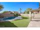 Backyard oasis with a sparkling pool, green artificial turf and stone patio, great for relaxation and entertaining at 20722 N 38Th St, Phoenix, AZ 85050