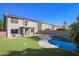 Lush backyard with a sparkling pool, patio, and well-maintained artificial grass for outdoor enjoyment at 20722 N 38Th St, Phoenix, AZ 85050