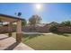 Inviting outdoor space with artificial grass, desert landscaping, custom patio, and refreshing pool under a clear sky at 20722 N 38Th St, Phoenix, AZ 85050
