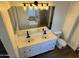 Bathroom with dual sink vanity, modern fixtures, wood-look floors, and glass block shower/tub enclosure at 20722 N 38Th St, Phoenix, AZ 85050