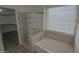 Bathroom with glass block shower, tub, modern fixtures, and wood-look floors at 20722 N 38Th St, Phoenix, AZ 85050