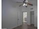 Bright bedroom featuring a ceiling fan, wood-look floors, and ensuite bathroom at 20722 N 38Th St, Phoenix, AZ 85050