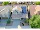 A home with desert landscaping, solar panels, a two car garage, and mature shade trees in an aerial shot at 20722 N 38Th St, Phoenix, AZ 85050