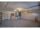 Spacious garage with epoxy flooring, built-in storage cabinets, and ample room for parking and projects at 20722 N 38Th St, Phoenix, AZ 85050
