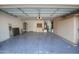 Open garage showcasing epoxy flooring, a wall of built-in cabinets, and plenty of space for vehicles and storage at 20722 N 38Th St, Phoenix, AZ 85050
