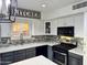 Modern kitchen featuring stainless steel appliances, updated countertop, stylish backsplash, and bright window at 20722 N 38Th St, Phoenix, AZ 85050