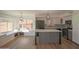 Bright, open kitchen with island, stainless appliances, and abundant natural light from a bay window at 20722 N 38Th St, Phoenix, AZ 85050
