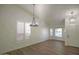 A sunlit living room with shuttered windows, contemporary chandelier and neutral walls with wood-look floors at 20722 N 38Th St, Phoenix, AZ 85050