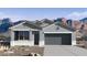 Charming single-story home with neutral paint, a two-car garage and mountain views at 22680 N Lynn St, Maricopa, AZ 85138